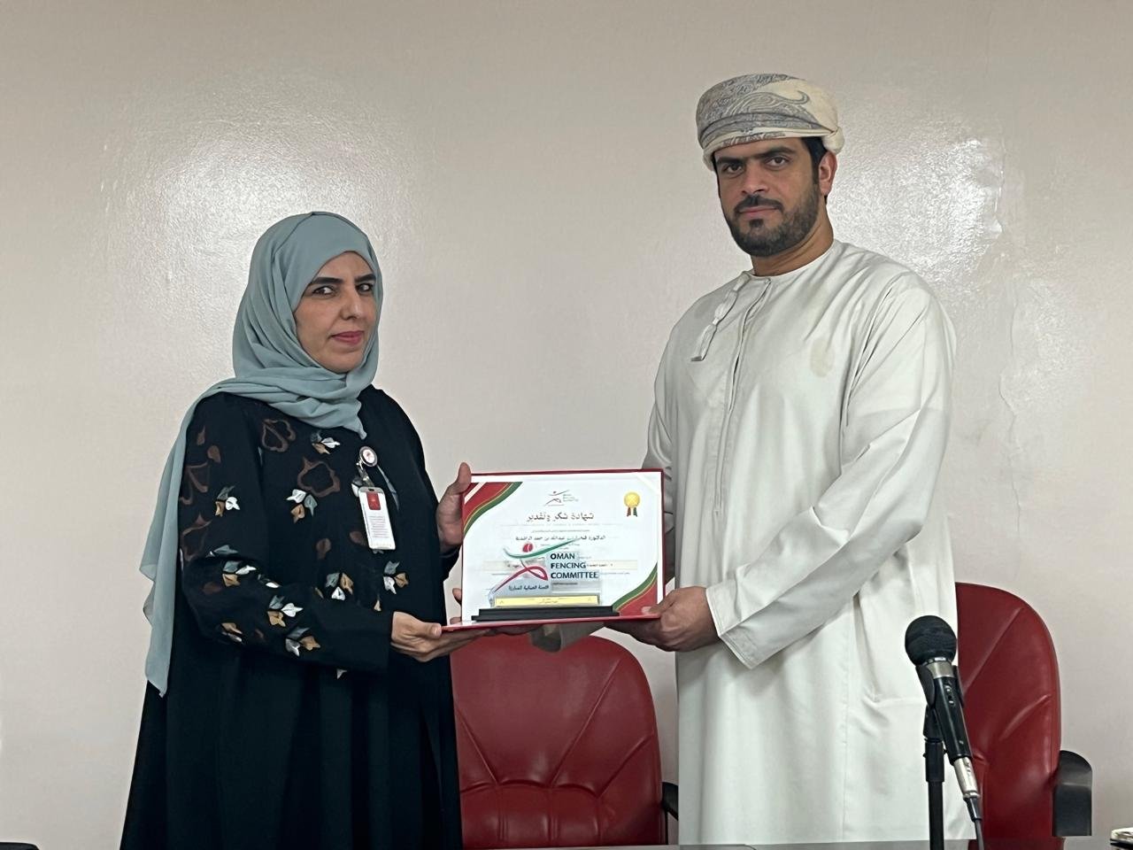 Captain Hisham Karshood, head coach of the national team, presenting a certificate of appreciation to Dr Fathiya Al Rashdi on behalf of the Oman Fencing Committee